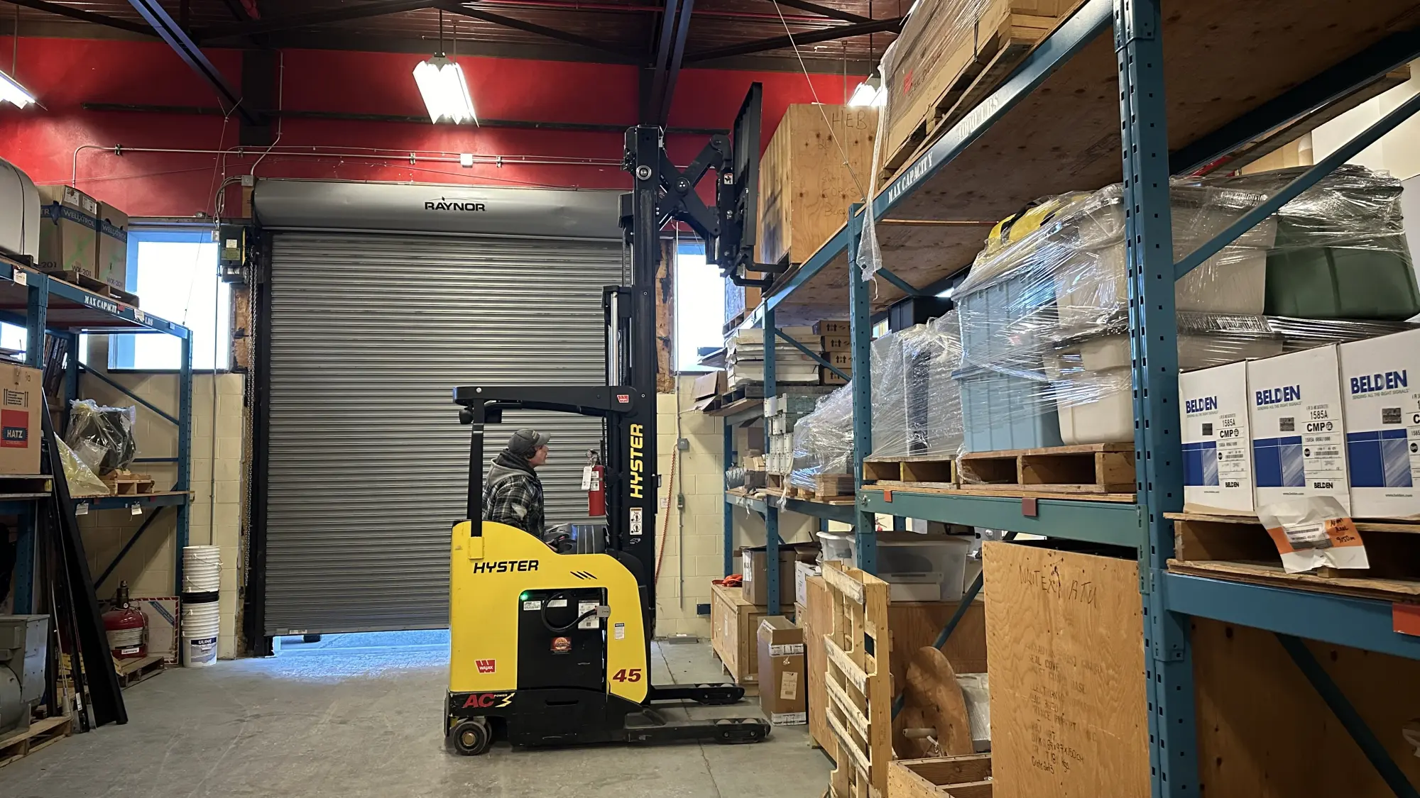 A student operating a Hyster reach truck during a hands-on training session provided by Karma Training. The training takes place in a warehouse setting, emphasizing practical skills and adherence to WorkSafeBC regulations. Karma Training is a premier safety training provider in Northwestern BC.